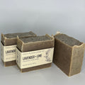 Three bars of soap with packaging on a light gray background